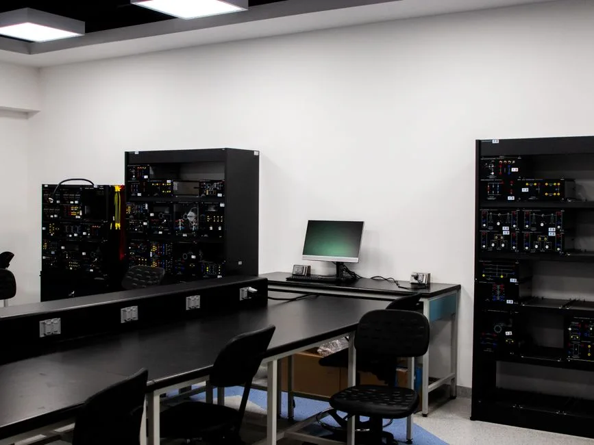 Un laboratorio de electrónica contemporánea con estaciones de trabajo y equipos técnicos.